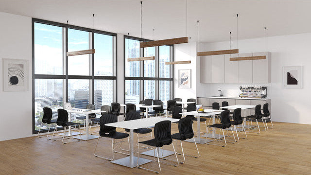 Modern office space with large windows, tables, and chairs.