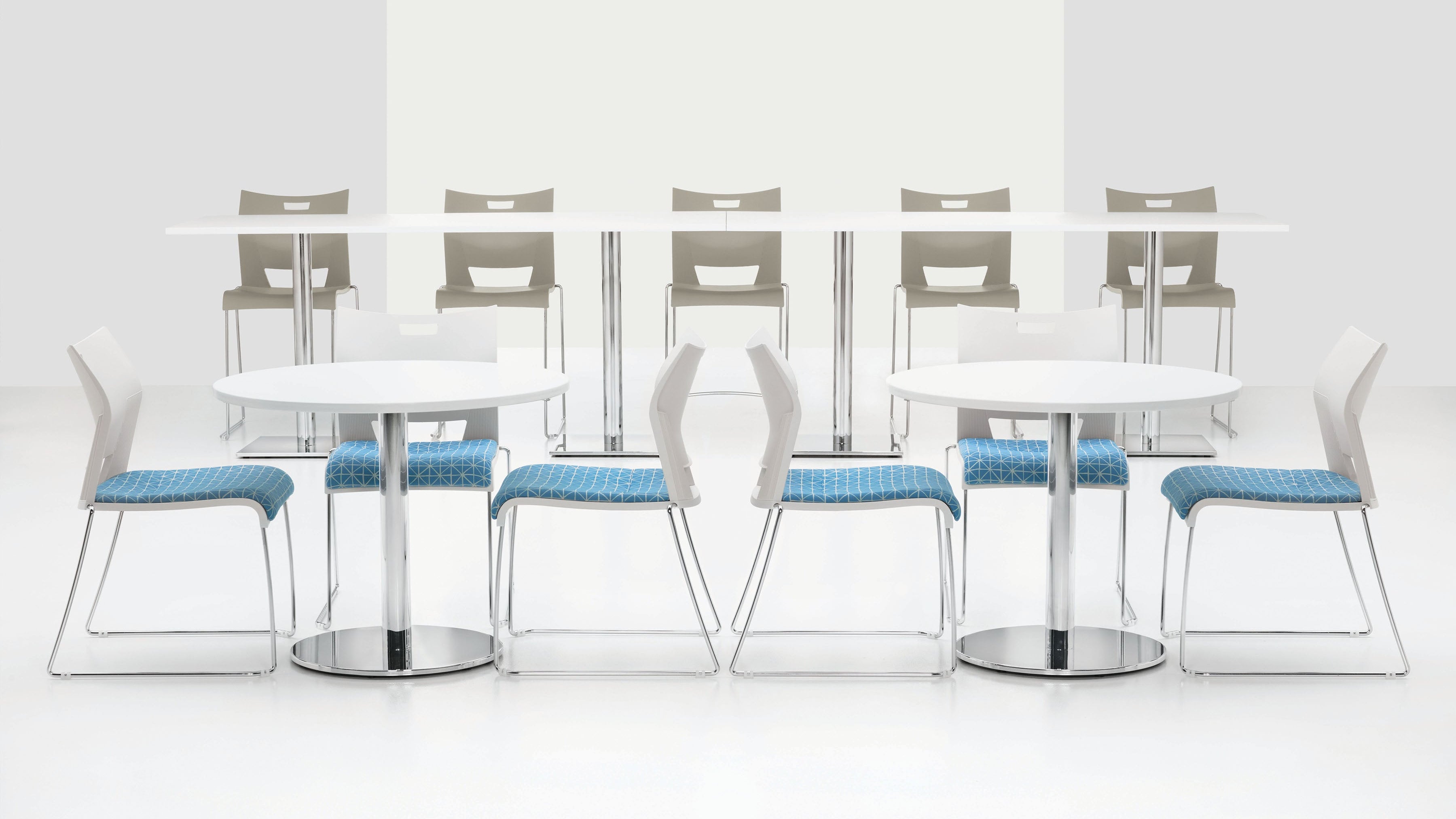 Set of modern chairs with blue seats around white tables on a white background