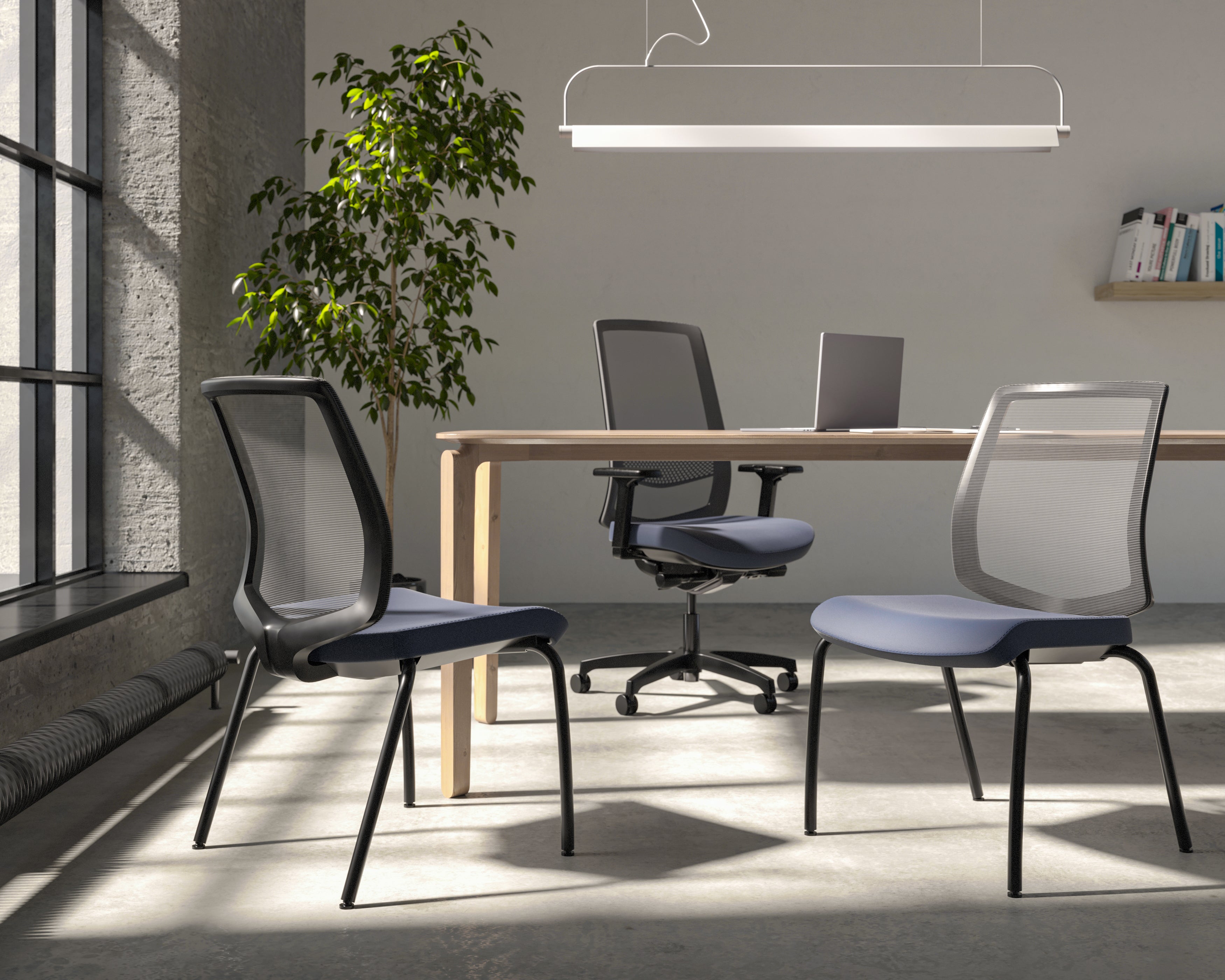 Modern office space with table and black chairs.