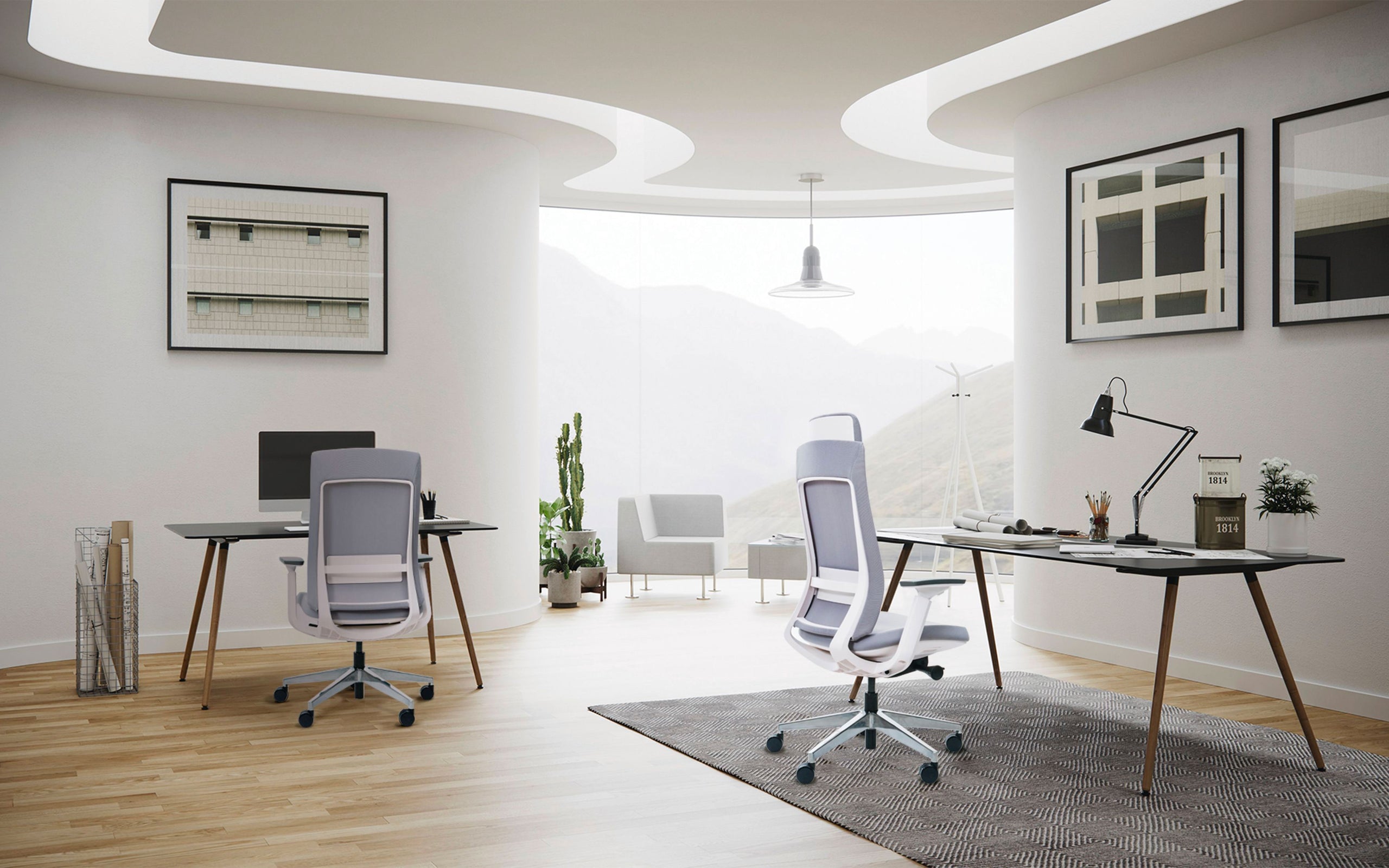 Modern office space with desks, white chairs, and organically shaped ceiling lights.