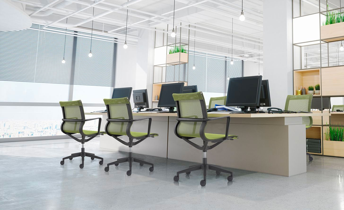 Modern office space with desks, green chairs, and large windows.