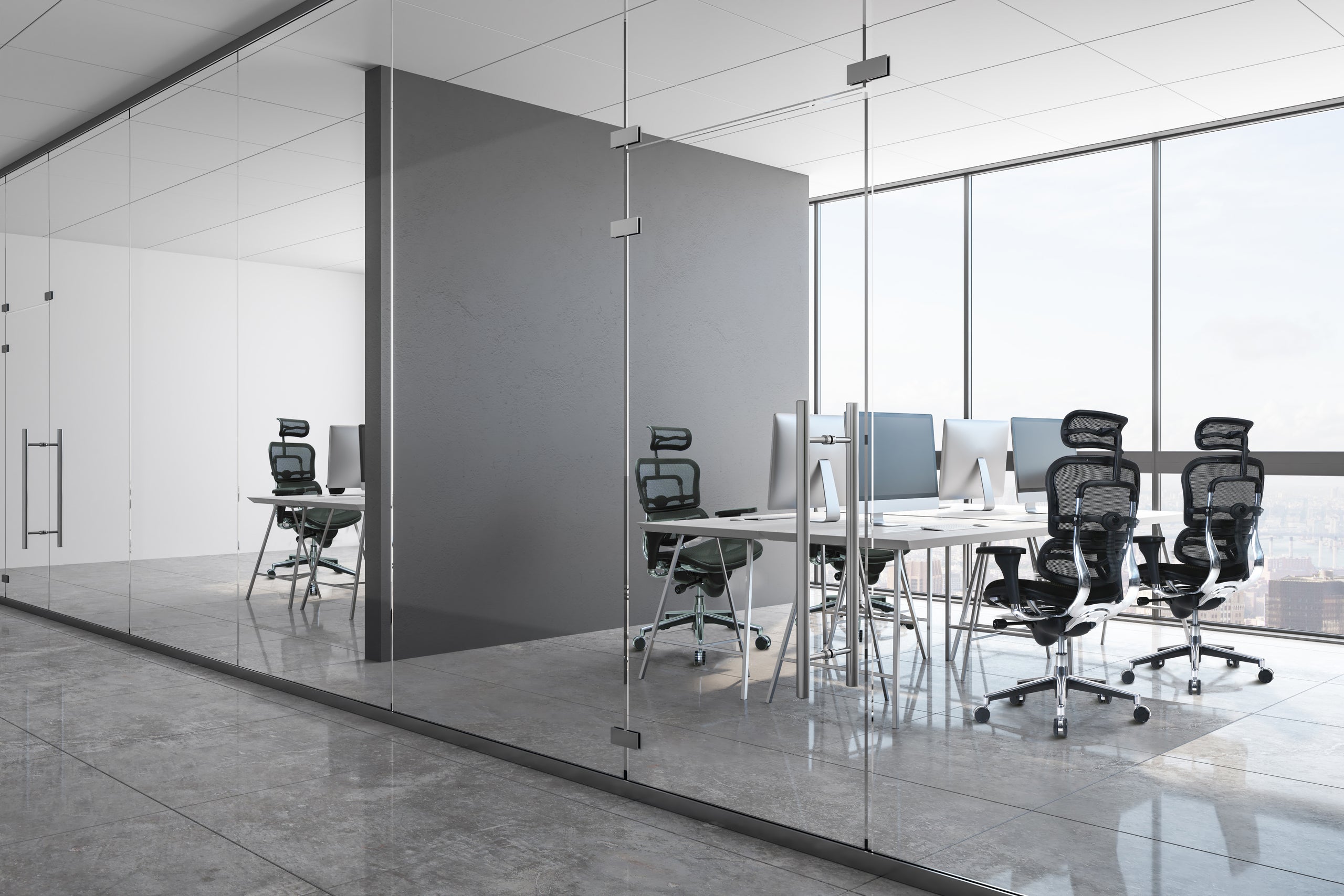 Modern office with glass walls and chairs around a table.